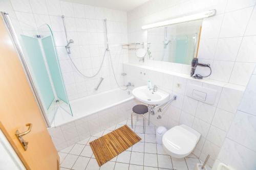 a bathroom with a sink and a toilet and a shower at Fewo Goldene Krone Leipzig mit Tiefgarage in Leipzig