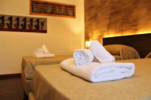 a hotel room with two towels on a bed at B&B Atlante in Palermo