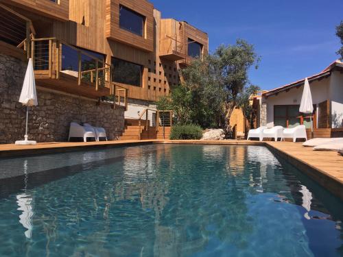 a swimming pool in front of a building at The Nest by Cooking and Nature in Alvados