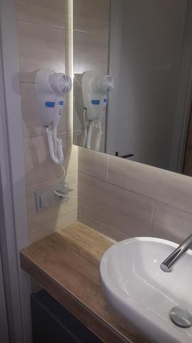 a bathroom counter with a sink and a mirror at Apartment 22 in Alexandroupoli