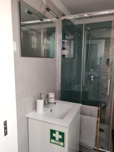 a bathroom with a sink and a shower at Casa da açoteia in Olhão