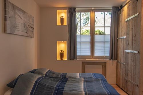 Un pat sau paturi într-o cameră la casa Heemskerk