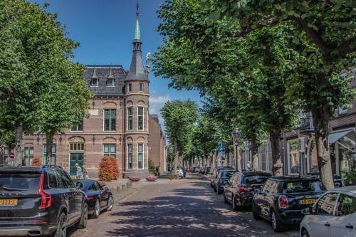 a street lined with parked cars in front of a building at casa Heemskerk in Noordwijk