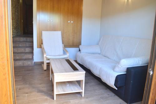 a living room with a couch and a table at Casa Cerrito in Cortes de Arenoso