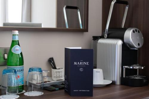 a bottle of wine and a box on a counter at Rooms at The Marine in Ballybunion