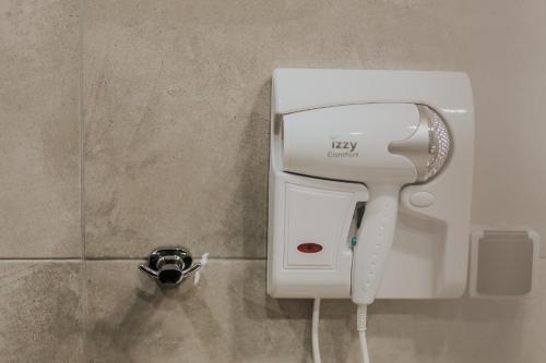 a hair dryer is attached to a wall at Unique Experience Apartment’s in Thessaloniki