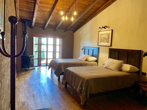 a bedroom with two beds and a fireplace in it at Hotel La Casa de Maty in Tapalpa