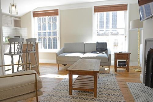 a living room with a couch and a table at Cathedral View Apartment, Flat 3 in Bury Saint Edmunds