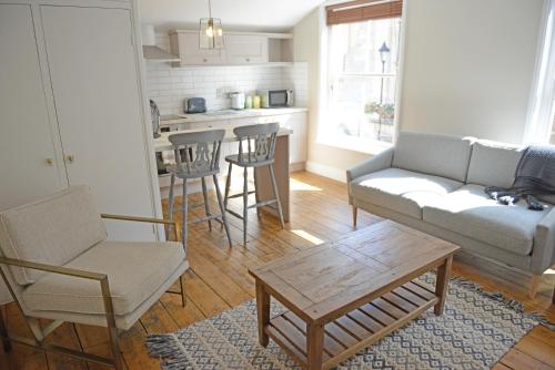 a living room with a couch and chairs and a table at Cathedral View Apartment, Flat 3 in Bury Saint Edmunds