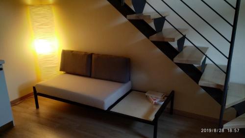 a bench in a room with a staircase at Bella Civita in Bagnoregio