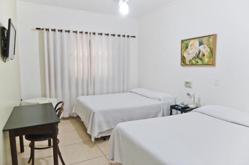 Ένα ή περισσότερα κρεβάτια σε δωμάτιο στο Hotel Pousada Ourinhos