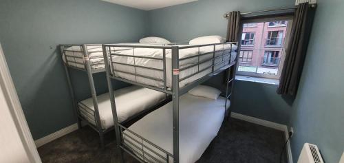 two bunk beds in a room with a window at Family apartments in Dublin