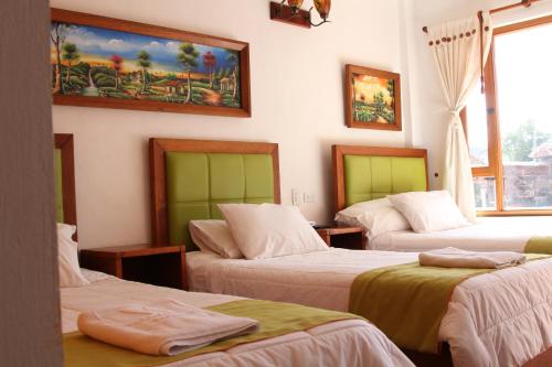 Postel nebo postele na pokoji v ubytování Hotel Villa Alegria
