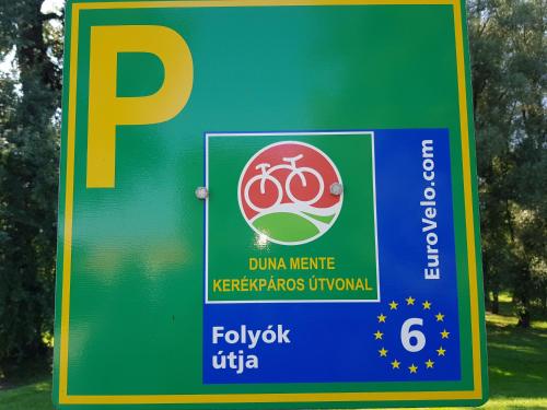 a sign for a park with two bikes on it at Duna Dráva Vendégház in Érsekcsanád