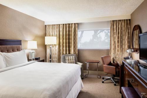 a hotel room with a bed and a television at Red Deer Resort & Casino in Red Deer