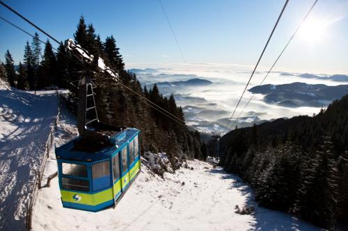 a ski lift going up a snow covered mountain at Entire Loft close to Beautiful Logar Valley in Rečica ob Savinji