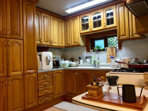 a kitchen with wooden cabinets and a counter top at BluePlanet in Gyeongju