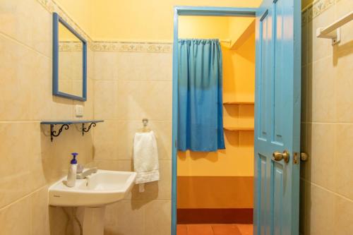 a bathroom with a sink and a mirror at Club Surf Popoyo in Popoyo