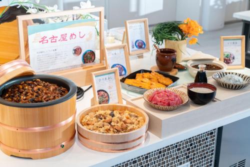 a buffet with different types of food on a table at Vessel Hotel Campana Nagoya in Nagoya