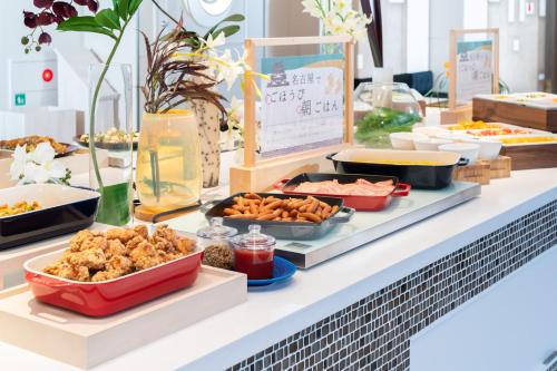 a buffet filled with food on a table at Vessel Hotel Campana Nagoya in Nagoya