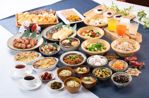 a table topped with lots of different types of food at Vessel Hotel Kanda Kitakyushu Airport in Kanda