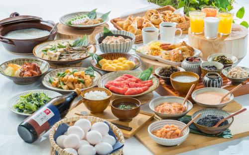 a table topped with lots of different types of food at Vessel Inn Hakata Nakasu in Fukuoka