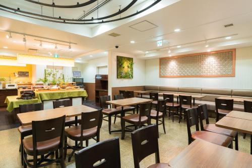 a dining room with wooden tables and chairs at Vessel Inn Hakata Nakasu in Fukuoka
