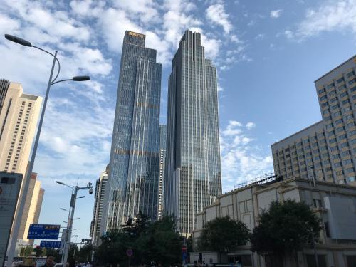 a group of tall buildings in a city at Qingdao Elegant Central Apartment in Qingdao