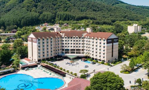an aerial view of a hotel with a large pool at Kensington Resort Gapyeong in Gapyeong
