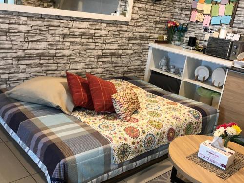 a room with a bed with pillows and a table at Non Smoking Theda Evo Soho Bangi with Coway & Wifi - Pool Tutup in Bangi