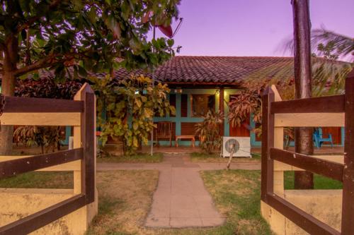 a house with a gate in front of a house at Club Surf Popoyo in Popoyo