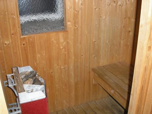 a wooden paneled room with a bench in a sauna at Hotel Chaplin in Landskrona