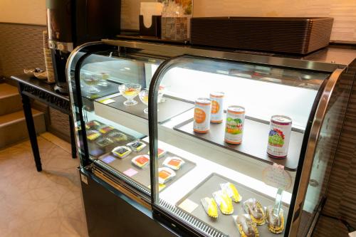 a display case in a restaurant with food in it at Hotel WILL Kashiwa (Adult Only) in Kashiwa