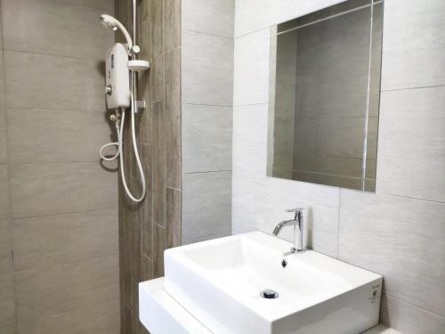 a bathroom with a white sink and a mirror at Arte Plus - Family Suite, 5 pax, Jalan Ampang in Kuala Lumpur