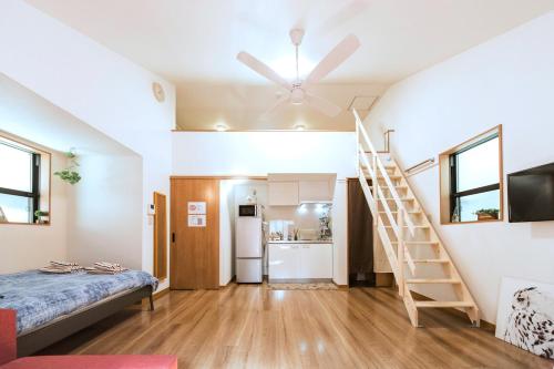 a room with a bed and a staircase in a house at nestay house tokyo itabashi 02 in Tokyo