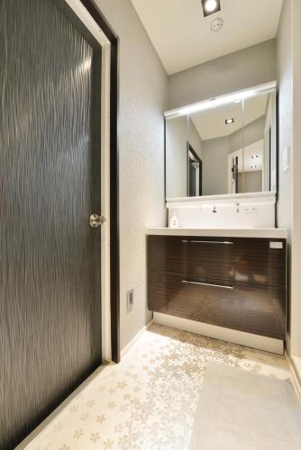 a bathroom with a sink and a mirror at Real Life Meguro River in Tokyo