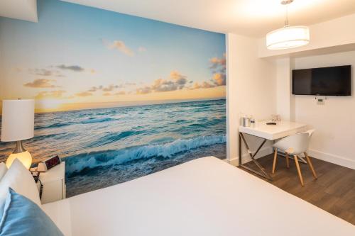 a bedroom with a painting of the ocean at President Hotel in Miami Beach