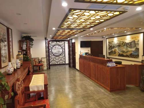 a lobby with a large clock in a building at Qinfu Hotel Beijing Nanluogu Lane Houhai in Beijing
