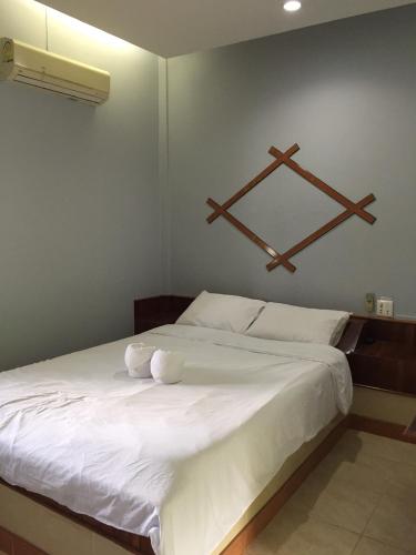 a bedroom with a large white bed with two pillows at First Garden Home Resort in Si Sa Ket