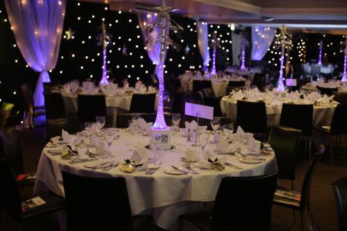 a banquet hall with tables with white tablecloths and chairs at Aston Hall Hotel, BW Signature Collection in Sheffield