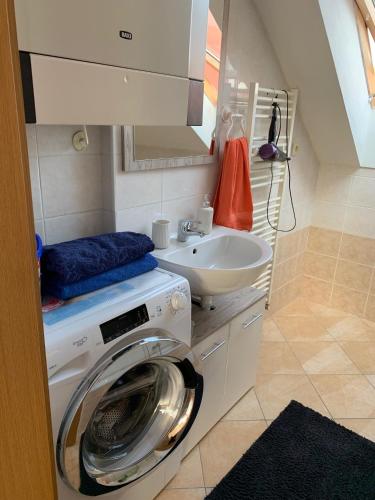 a washing machine and a sink in a bathroom at apartment in Biely Kostol