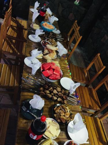 a long table with many plates of food on it at Villa Edemi in Tskaltubo