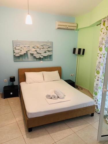 a bedroom with a bed with two towels on it at Schoinaria Bay in Damnoni