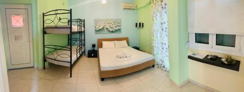 a small room with a bed and a shelf at Schoinaria Bay in Damnoni