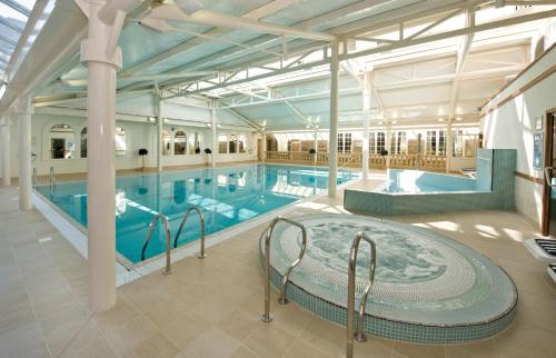 a large indoor pool with a large swimming pool at Orton Hall Hotel & Spa in Peterborough