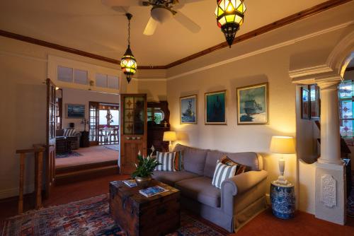 a living room with a couch and a table at The Cheriton Guest House in Simonʼs Town