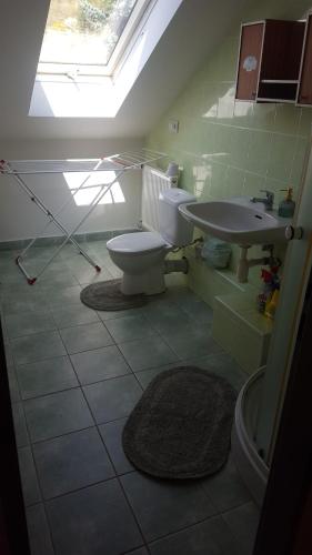 a bathroom with a toilet and a sink at Ubytovanie Aďka in Levoča