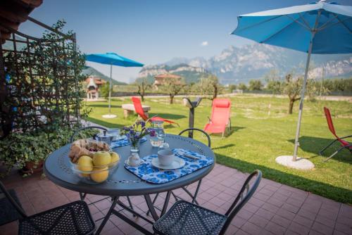 a table with a bowl of fruit on a patio at Agriturismo Trefrutti in Arco