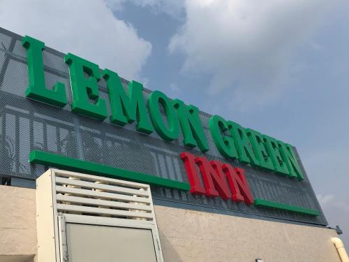 a sign on the side of a store at Lemon Green Inn in New Delhi