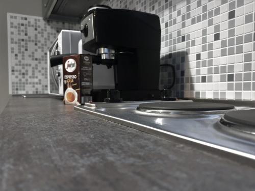 a counter top with a coffee maker on it at Irina Apartments in Timişoara